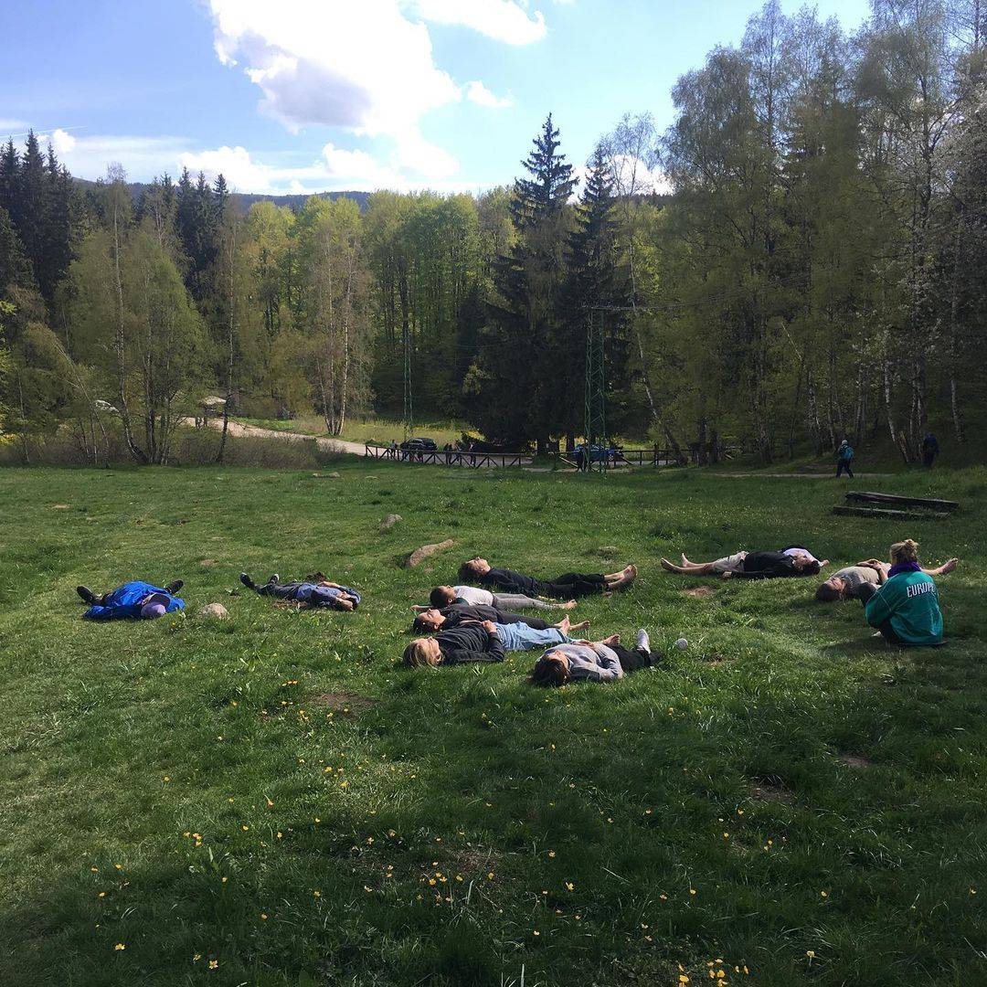 People lying on the ground in nature.